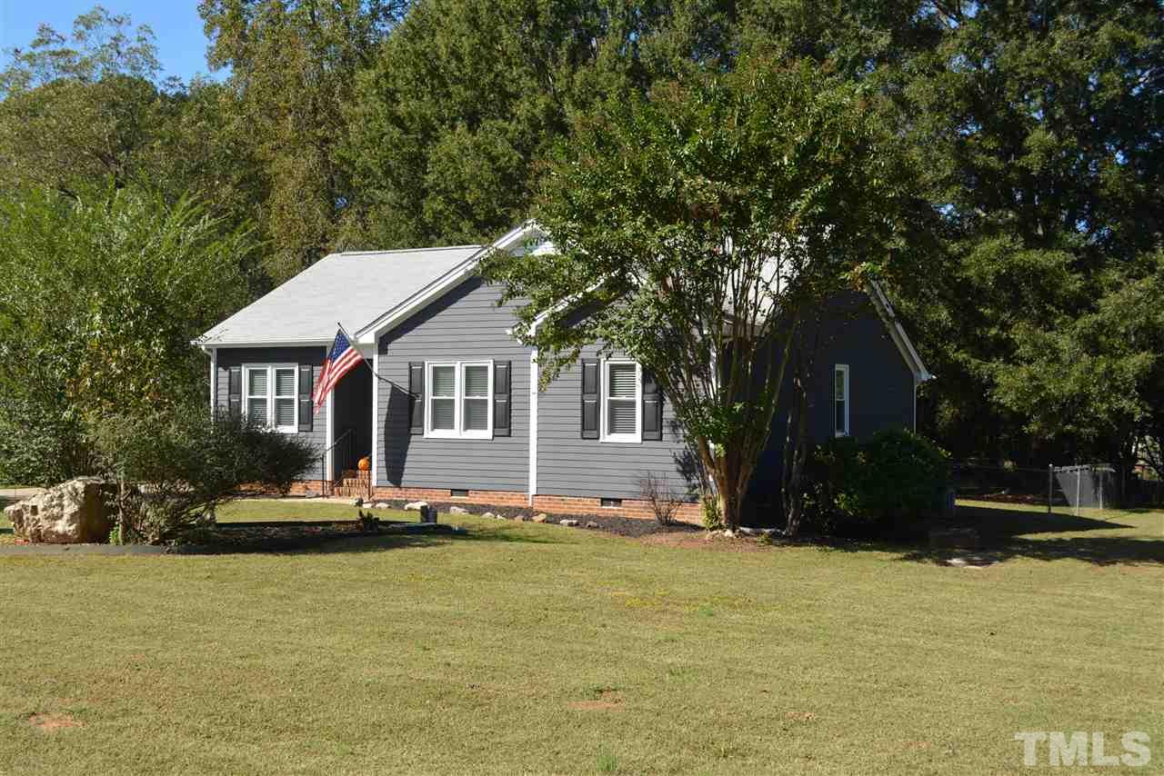 5236 Carrier Way Raleigh, NC 27603 - Photo 2 of 22 All new exterior designer Peppercorn Gray color paint for the siding, new white trim paint, new black shutters, recent newer roof, beautiful lot with fenced yard to enjoy.