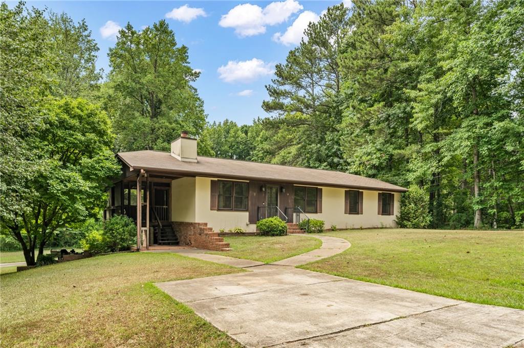 525 Tarpley Road Northwest Kennesaw, GA 30152 - Photo 1 of 1 a front view of house with yard and green space