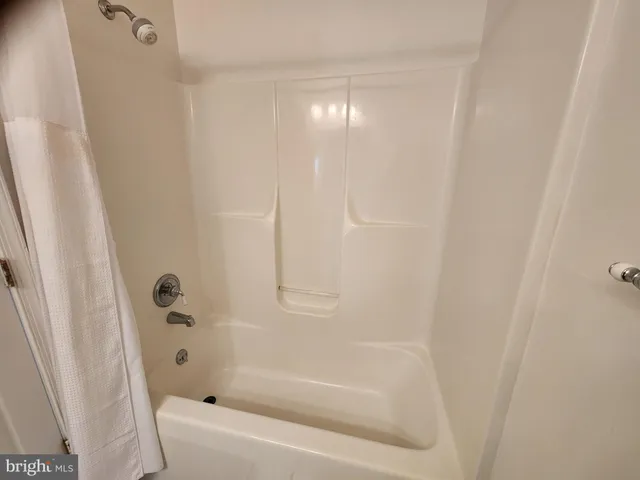 en empty room with windows and fireplace