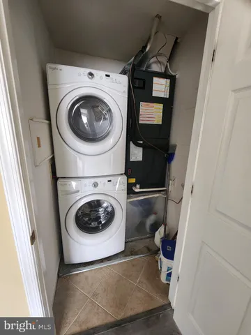 a backyard of a house with barbeque oven table and chairs
