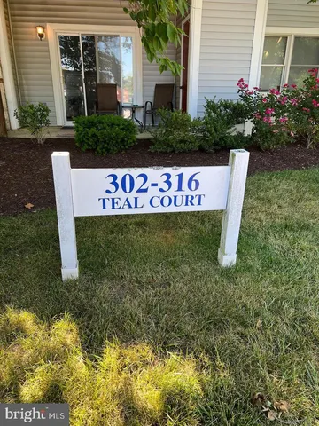 a sign that is sitting in front of a house