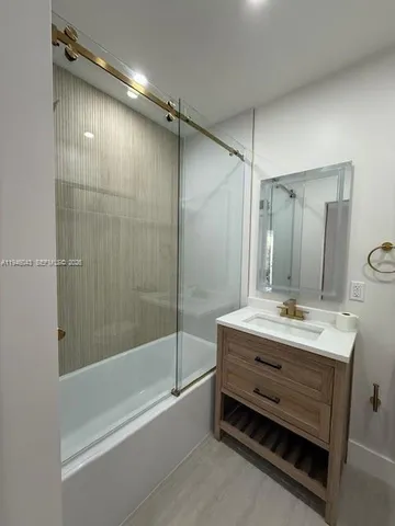 a bathroom with a double vanity sink mirror double and shower