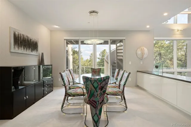 a dining room with furniture and a floor to ceiling window