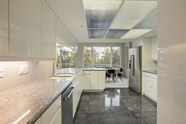a view of a kitchen with a sink and cabinets