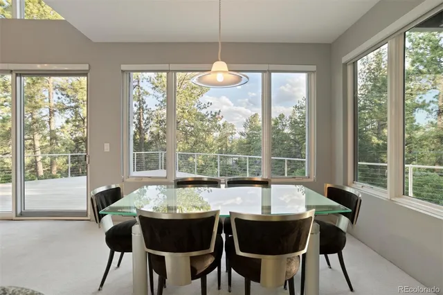 a dining room with furniture window and outside view