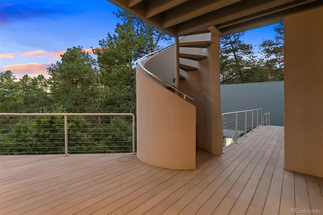 a view of a balcony with wooden floor and fence