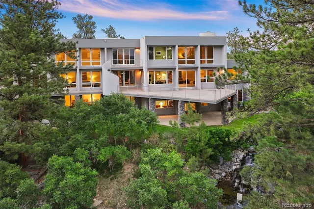an aerial view of a brick house next to a big yard
