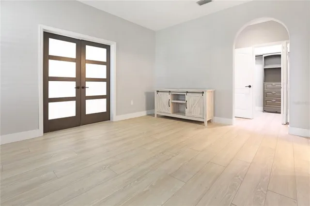 an empty room with windows and closet