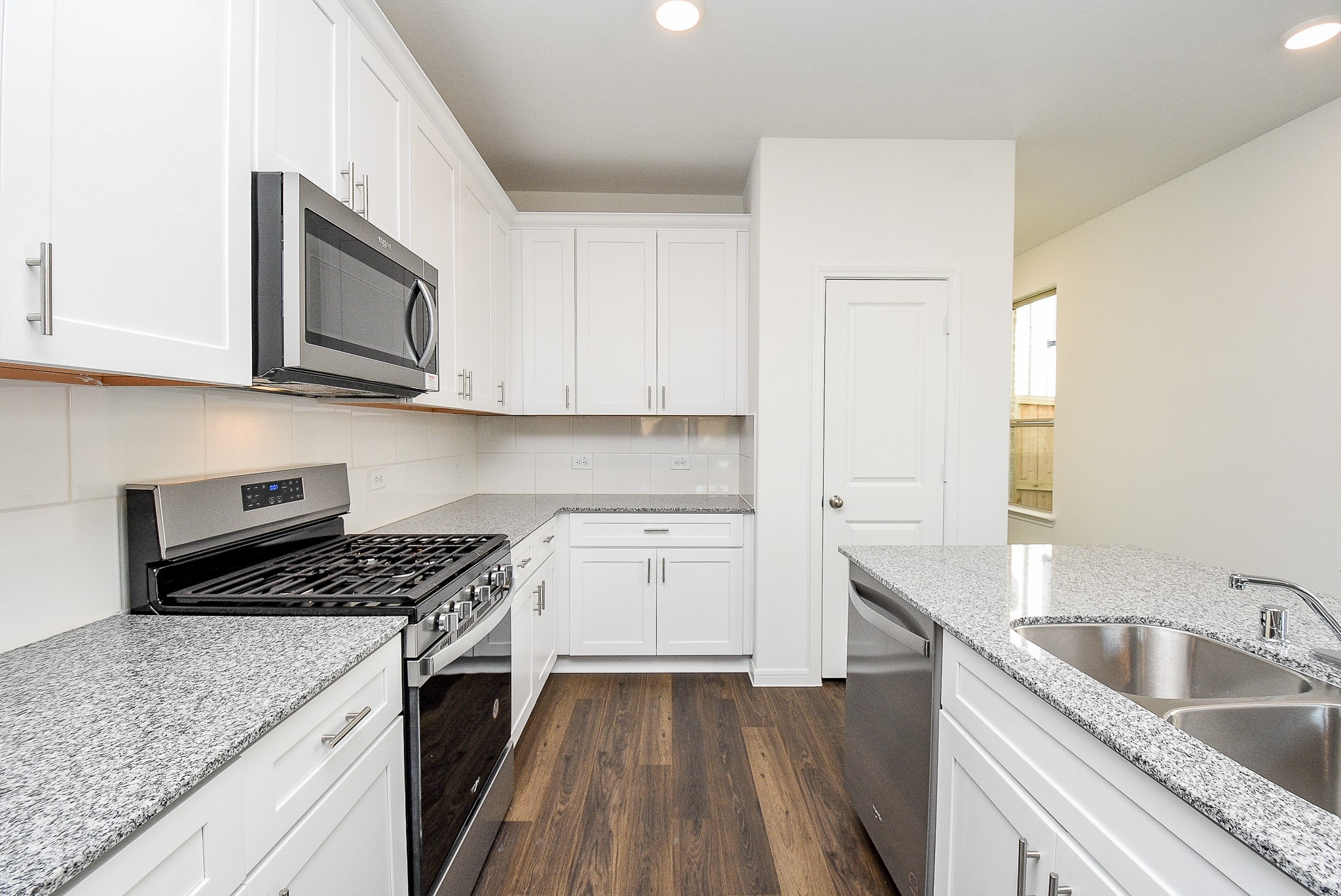 14499 Cedar Br Lane Conroe, TX 77302 - Photo 12 of 32 a kitchen with granite countertop a sink a stove and cabinets