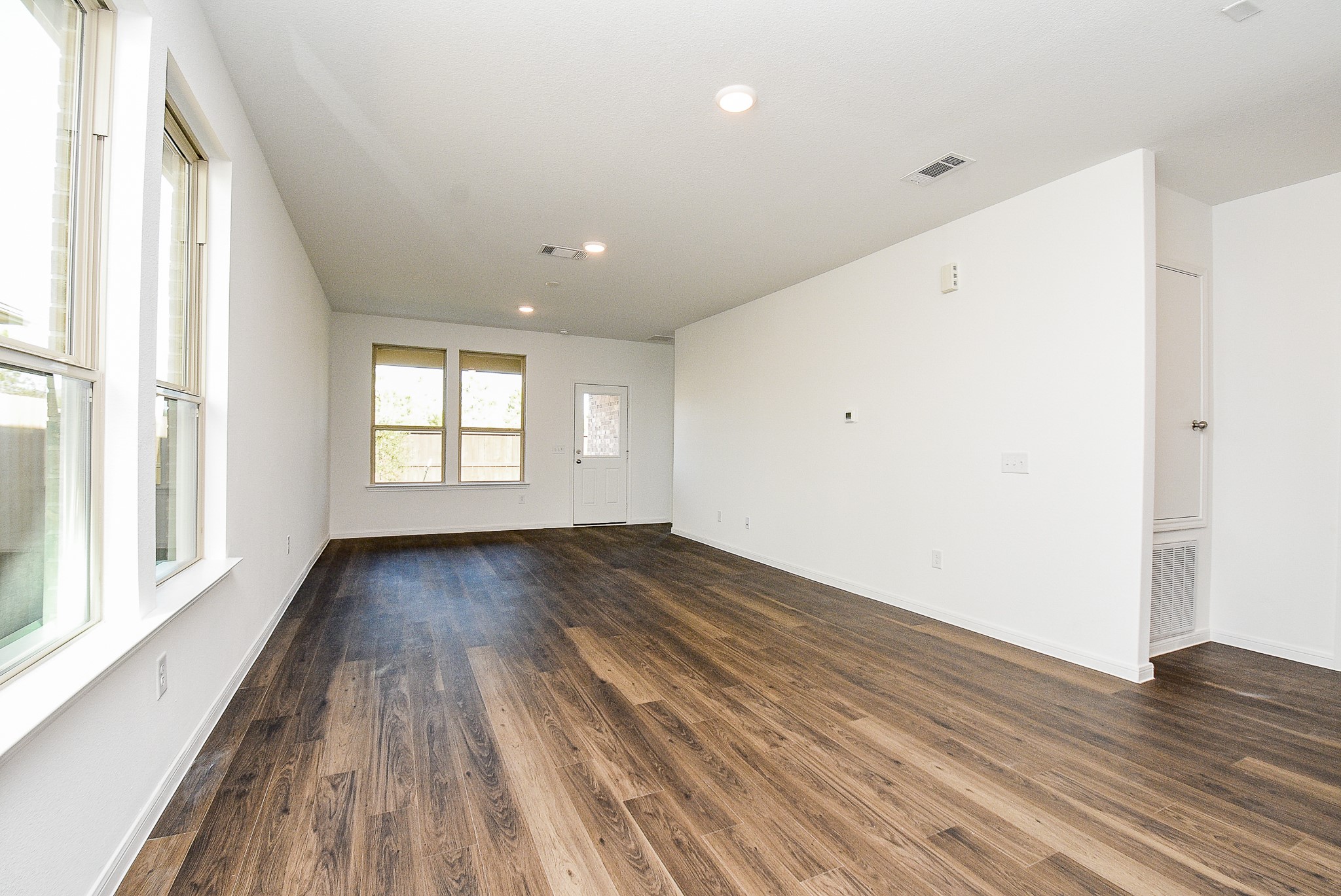 14499 Cedar Br Lane Conroe, TX 77302 - Photo 16 of 32 a view of an empty room with wooden floor and window