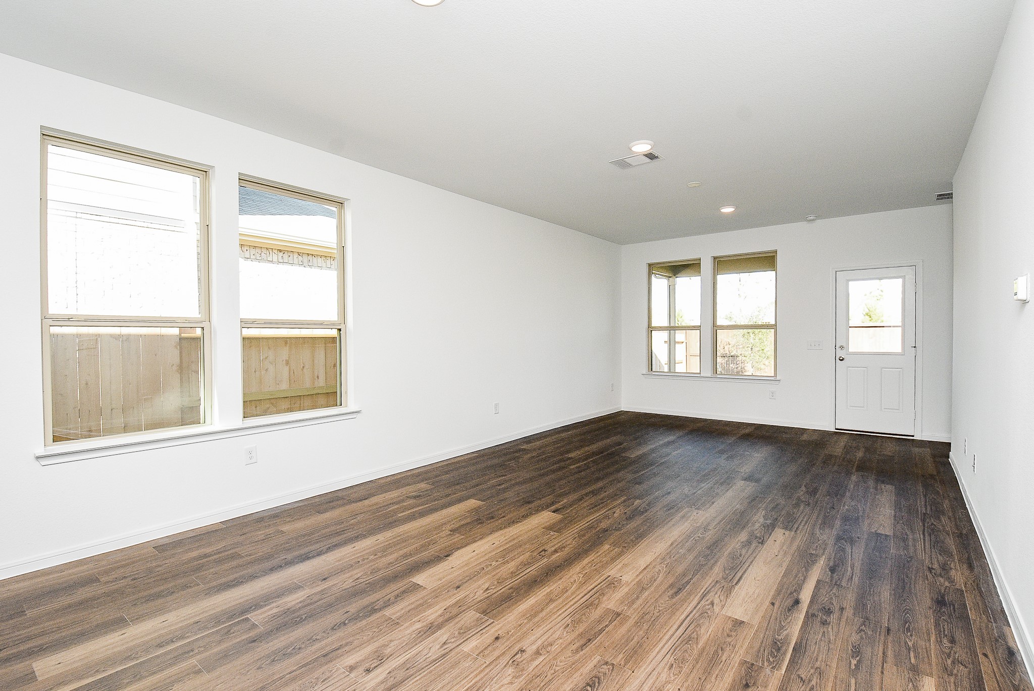 14499 Cedar Br Lane Conroe, TX 77302 - Photo 17 of 32 an empty room with wooden floor and windows