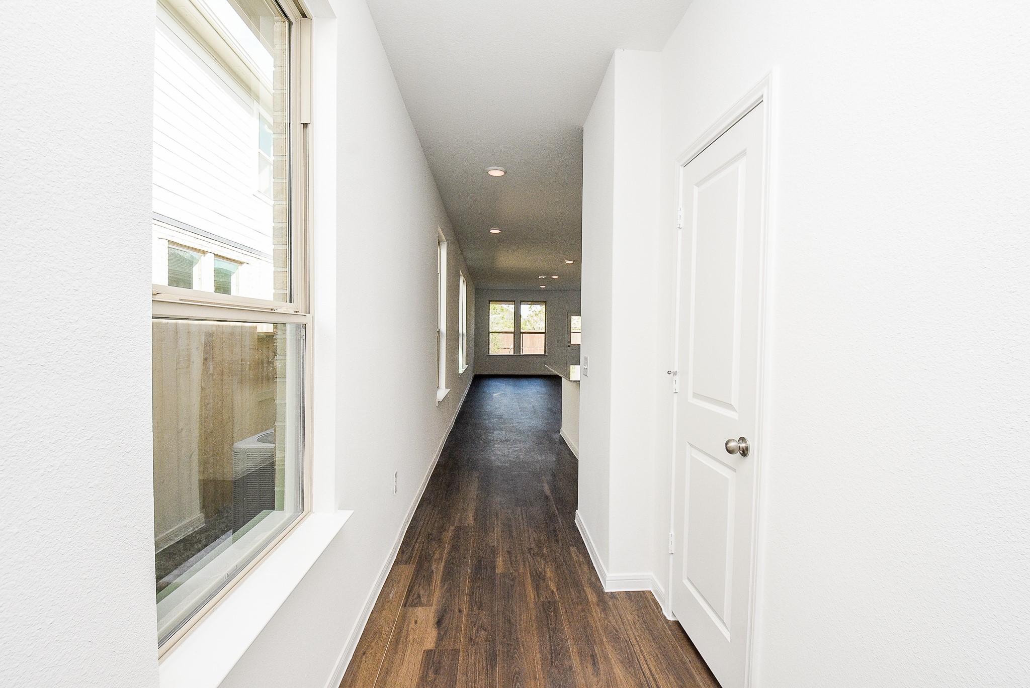 14499 Cedar Br Lane Conroe, TX 77302 - Photo 8 of 32 a view of a hallway with wooden floor and a bathroom