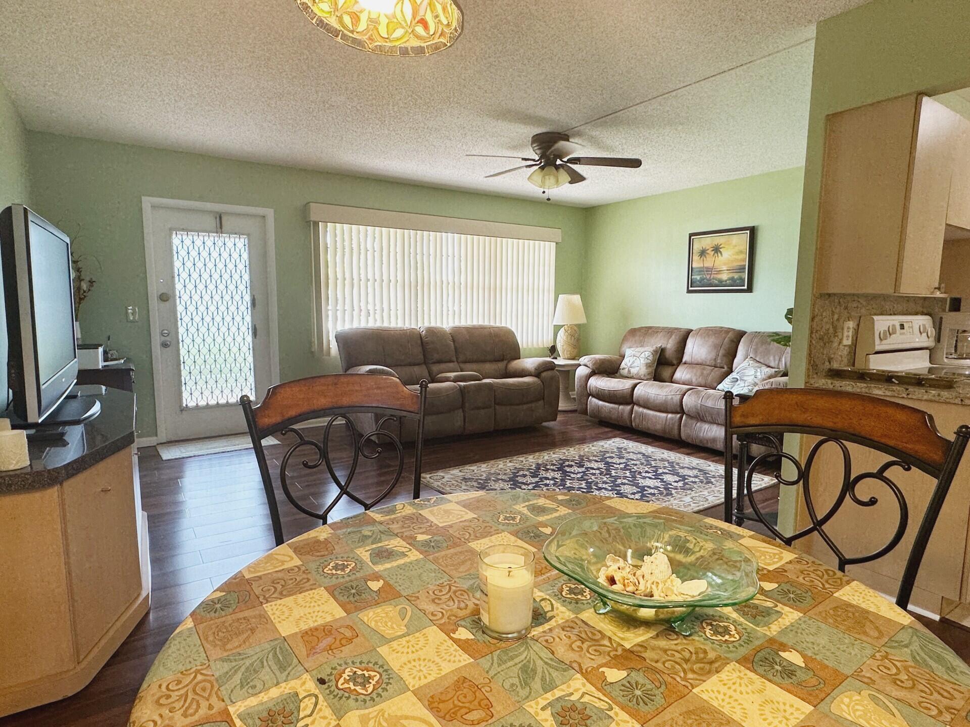 1094 Cornwall East Boca Raton, FL 33434 - Photo 9 of 35 a living room with furniture and a flat screen tv