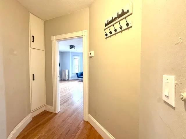 a view of a hallway with wooden floor