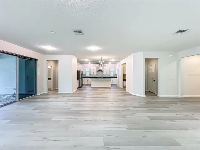 a kitchen with stainless steel appliances granite countertop a sink a stove a refrigerator a center island and cabinets