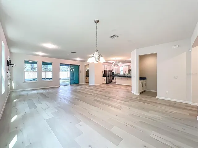 a kitchen with kitchen island granite countertop a stove and a sink