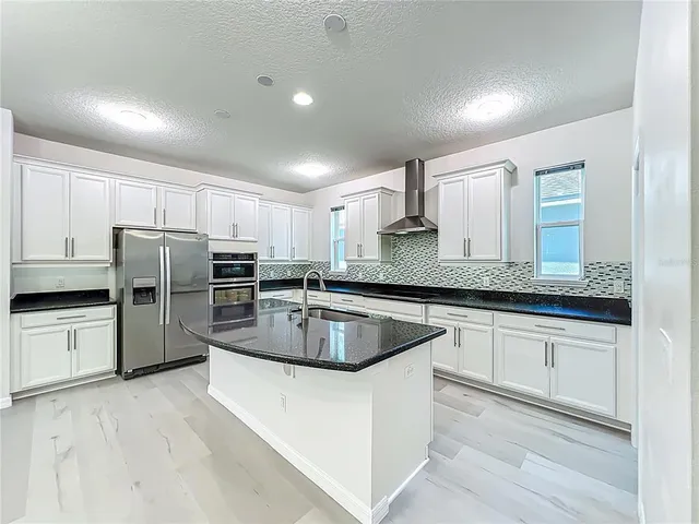 a view of a hallway with entryway wooden floor and front door