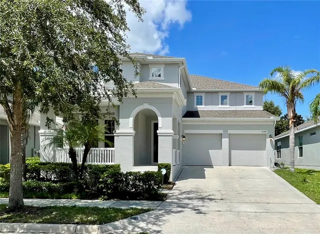 a front view of a house with a yard garage and outdoor seating