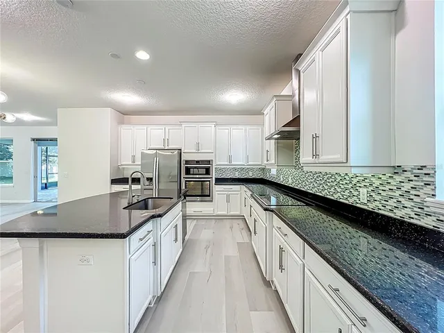 a view of a hallway with entryway wooden floor and front door