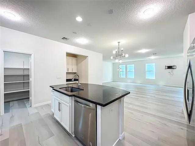 a living room with furniture a flat screen tv and a wooden floor
