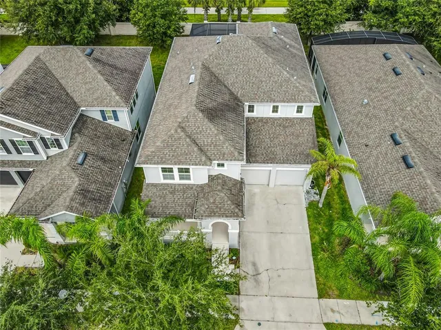 an aerial view of a house with a yard