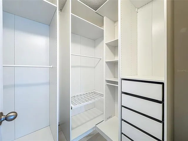 a view of a swimming pool with a table and chairs under an umbrella