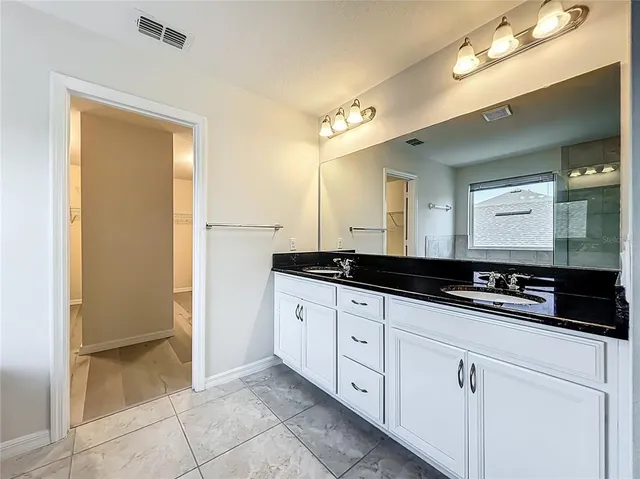 an aerial view of a house with swimming pool and outdoor seating