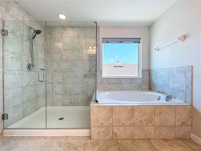 an aerial view of a house with swimming pool and outdoor seating