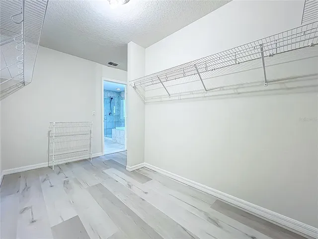 a living room with dining room and a flat screen tv