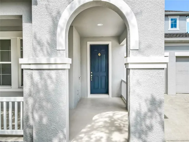 a view of a porch with wooden floor and a window