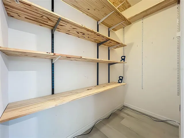 a large kitchen with granite countertop a large counter top appliances cabinets and stainless steel appliances