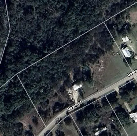 a view of a house with a yard covered in snow