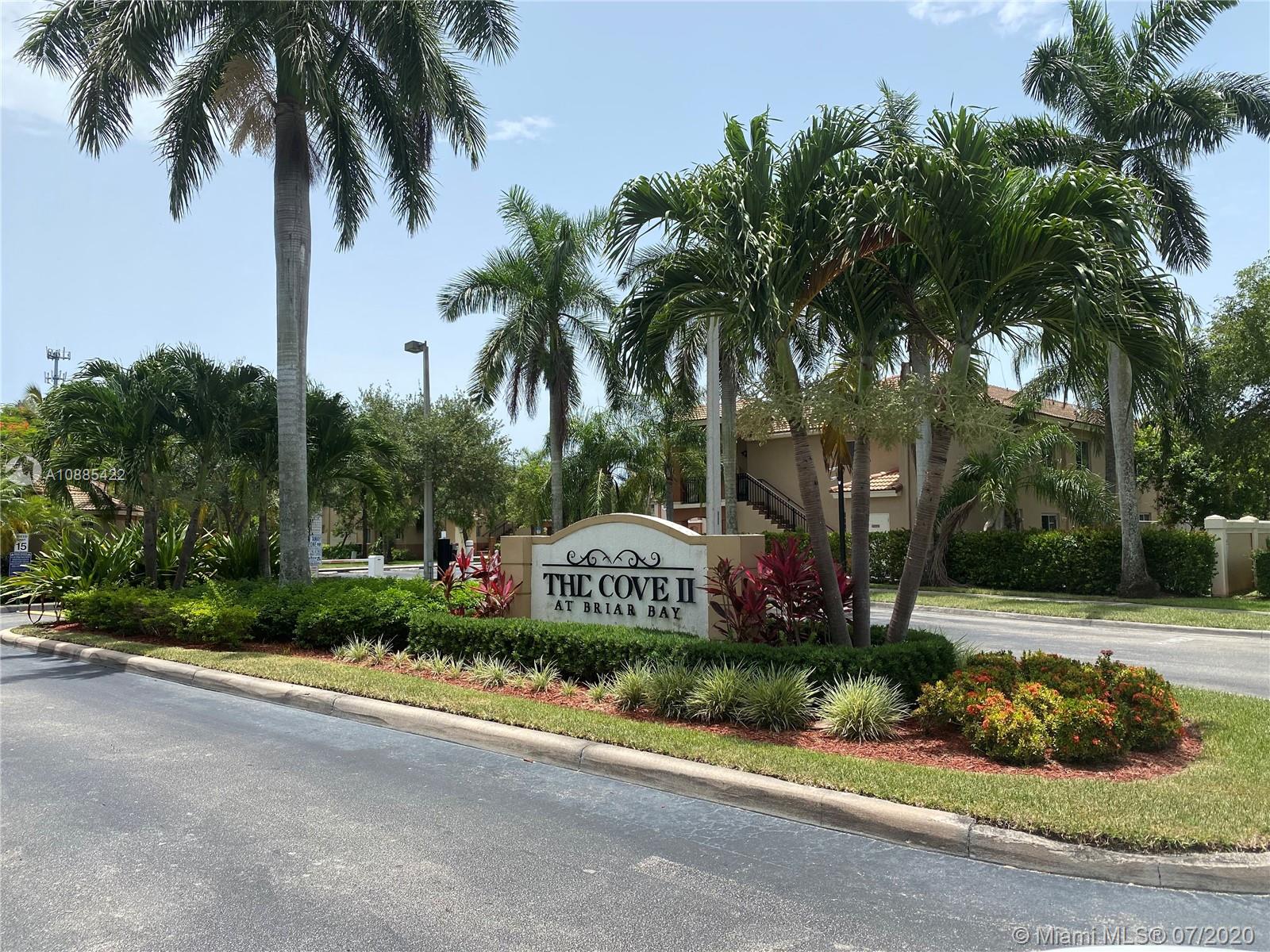 3750 North Jog Road, Unit 105 West Palm Beach, FL 33411 - Photo 1 of 8 a front view of a house with garden and trees