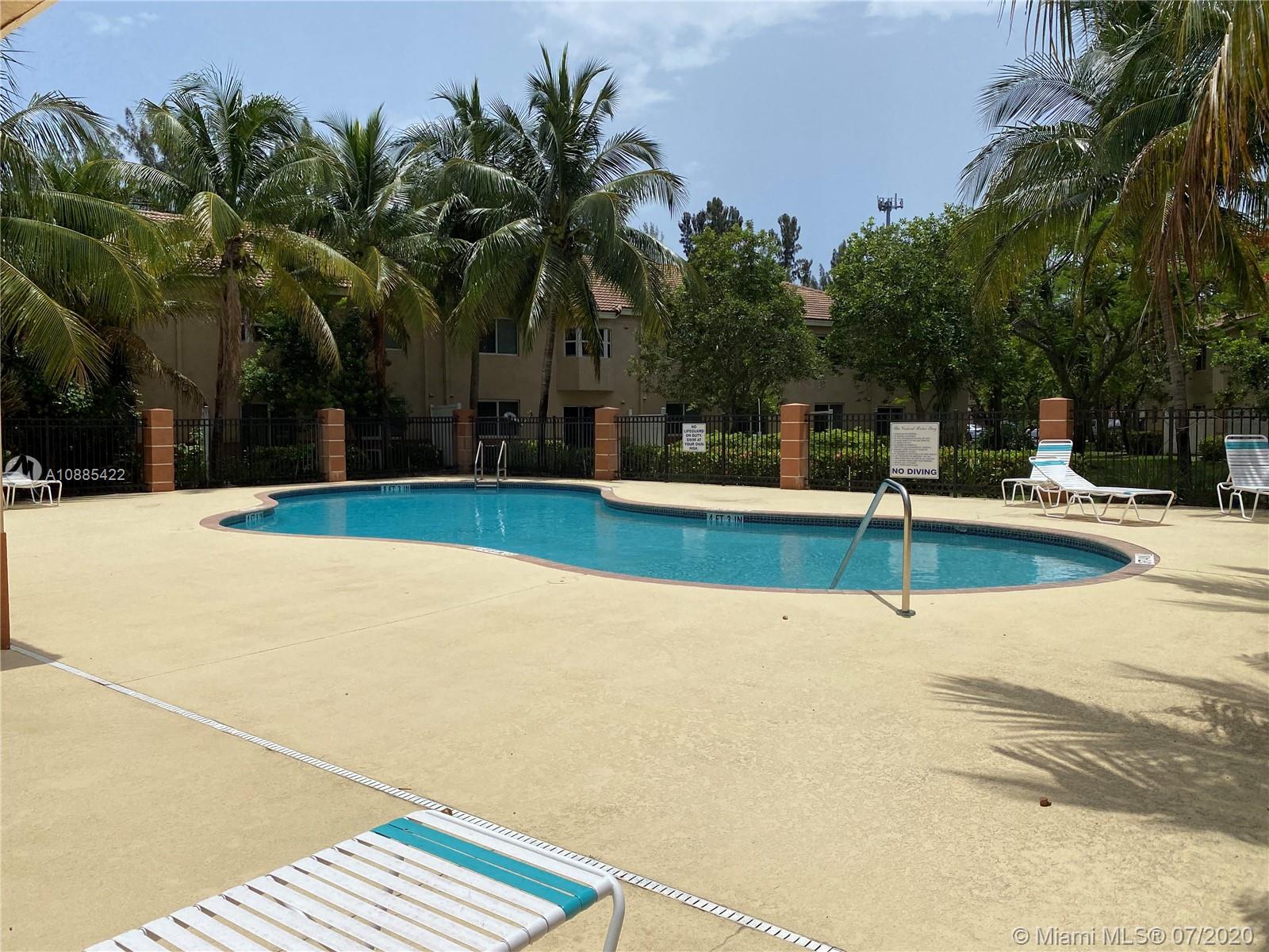 3750 North Jog Road, Unit 105 West Palm Beach, FL 33411 - Photo 2 of 8 a view of outdoor space yard and swimming pool