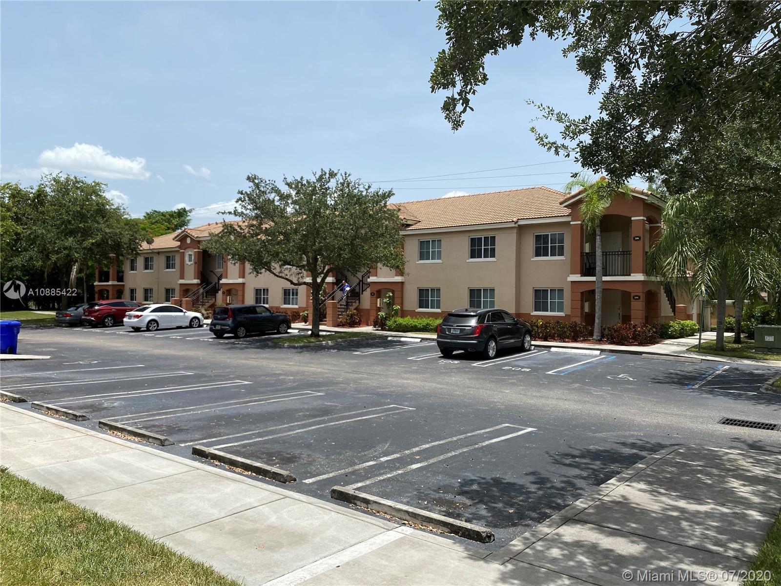3750 North Jog Road, Unit 105 West Palm Beach, FL 33411 - Photo 6 of 8 a view of street with parked cars
