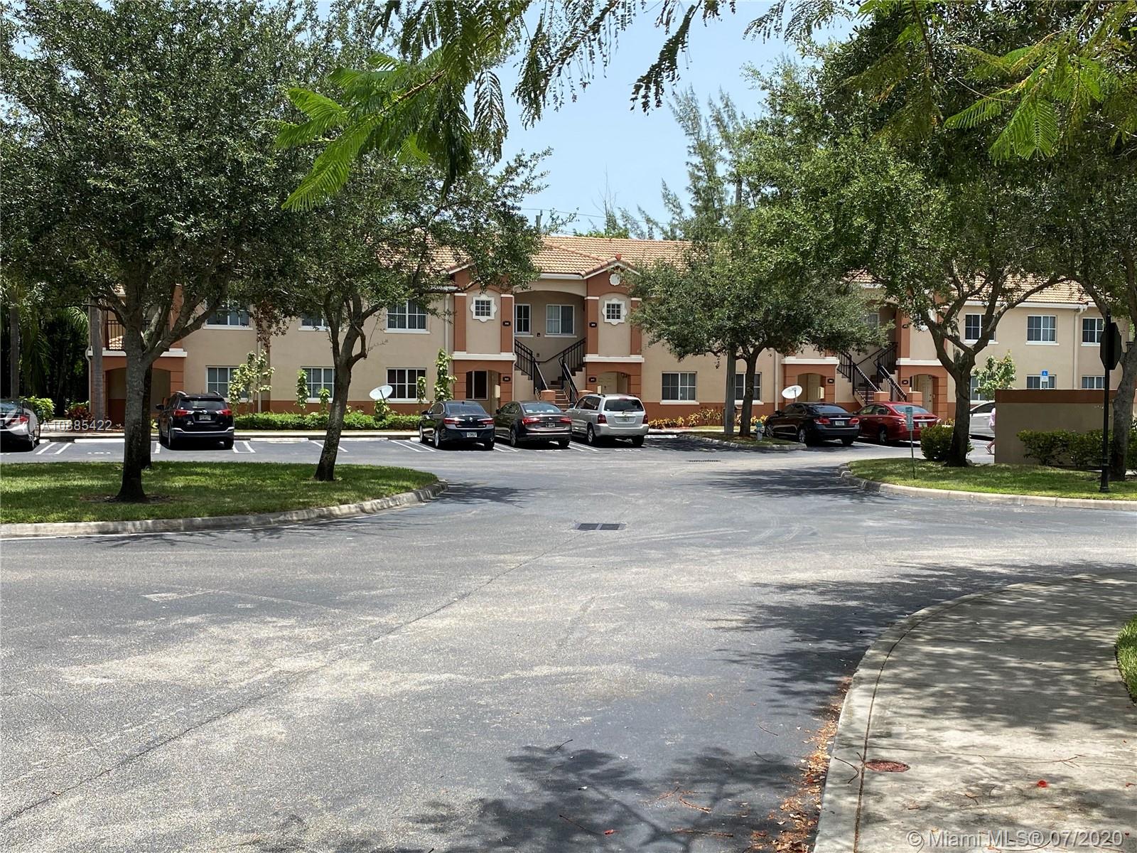 3750 North Jog Road, Unit 105 West Palm Beach, FL 33411 - Photo 7 of 8 a row of parked cars parked in front of a building
