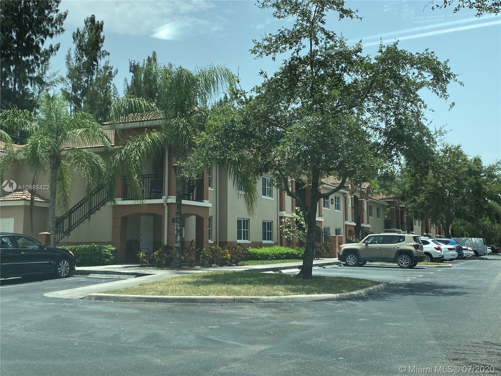 3750 North Jog Road, Unit 105 West Palm Beach, FL 33411 - Photo 8 of 8 a building with trees in front of it