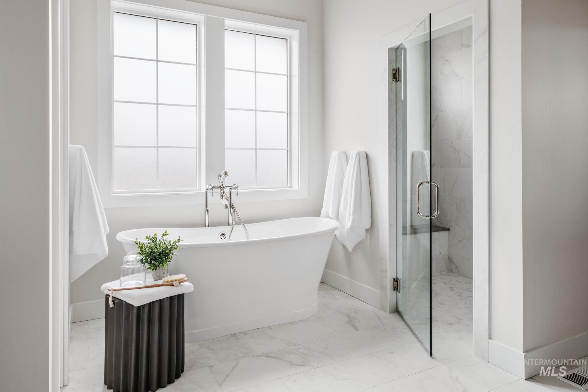 7448 North Cavea Lane Meridian, ID 83646 - Photo 15 of 40 Full bathroom with a marble finish shower, light marble finish flooring, and a freestanding bath