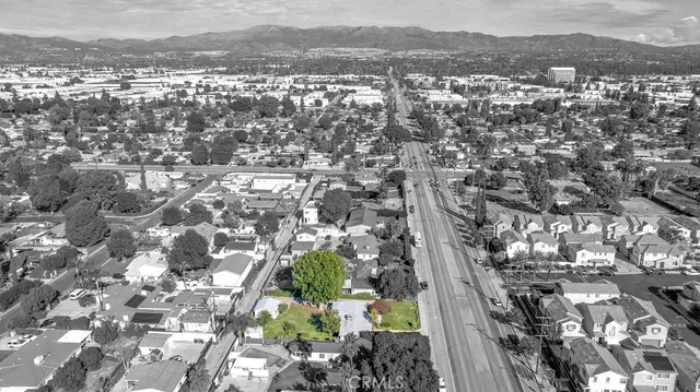 an aerial view of residential houses with city view