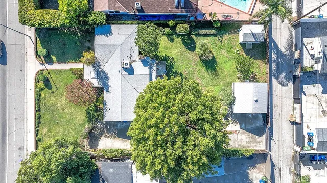 an aerial view of a house with a yard and garden