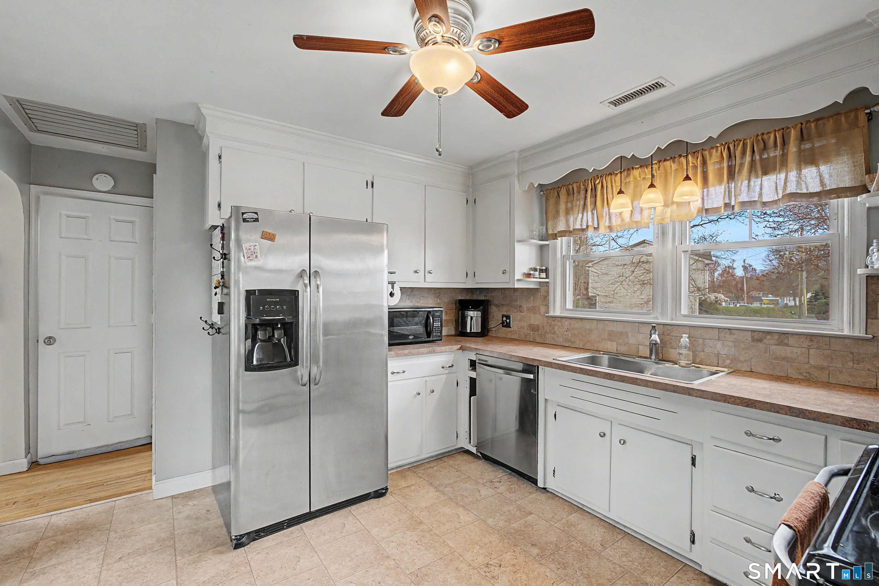 65 Jones Hill Road West Haven, CT 06516 - Photo 11 of 40 a kitchen with a sink stainless steel appliances cabinets and a window