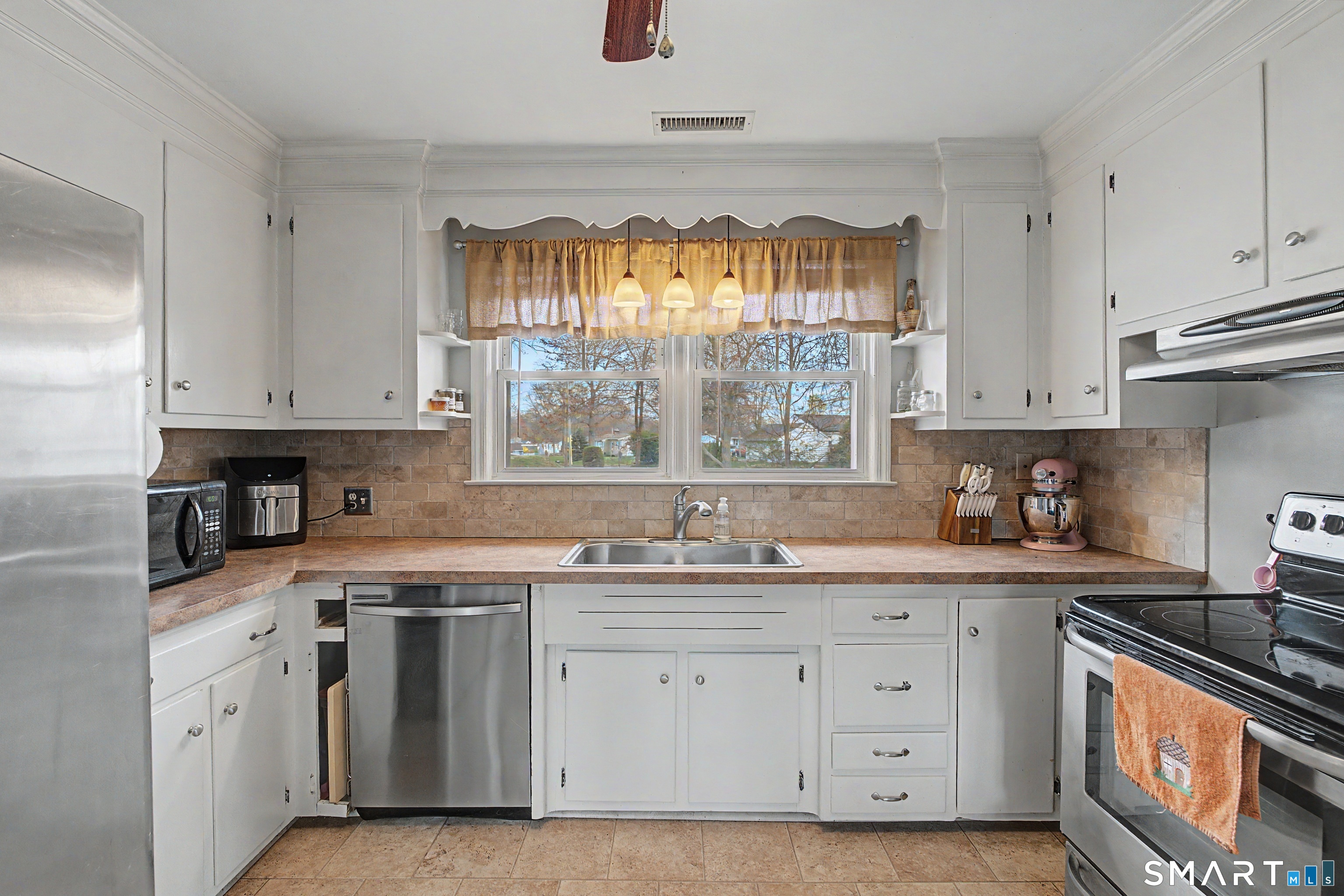 65 Jones Hill Road West Haven, CT 06516 - Photo 12 of 40 a kitchen with a sink stove and cabinets