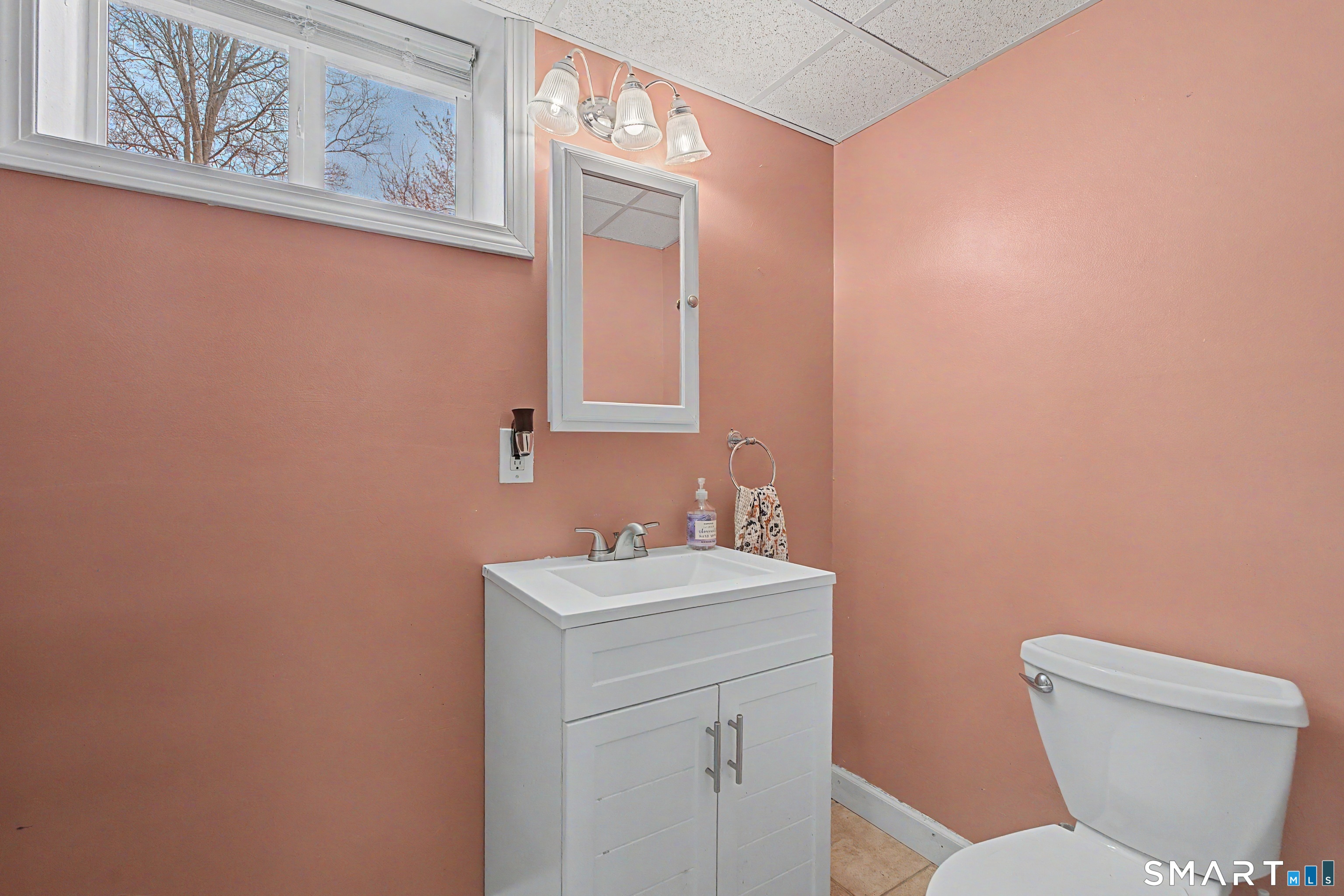 65 Jones Hill Road West Haven, CT 06516 - Photo 19 of 40 a bathroom with a toilet a sink and mirror