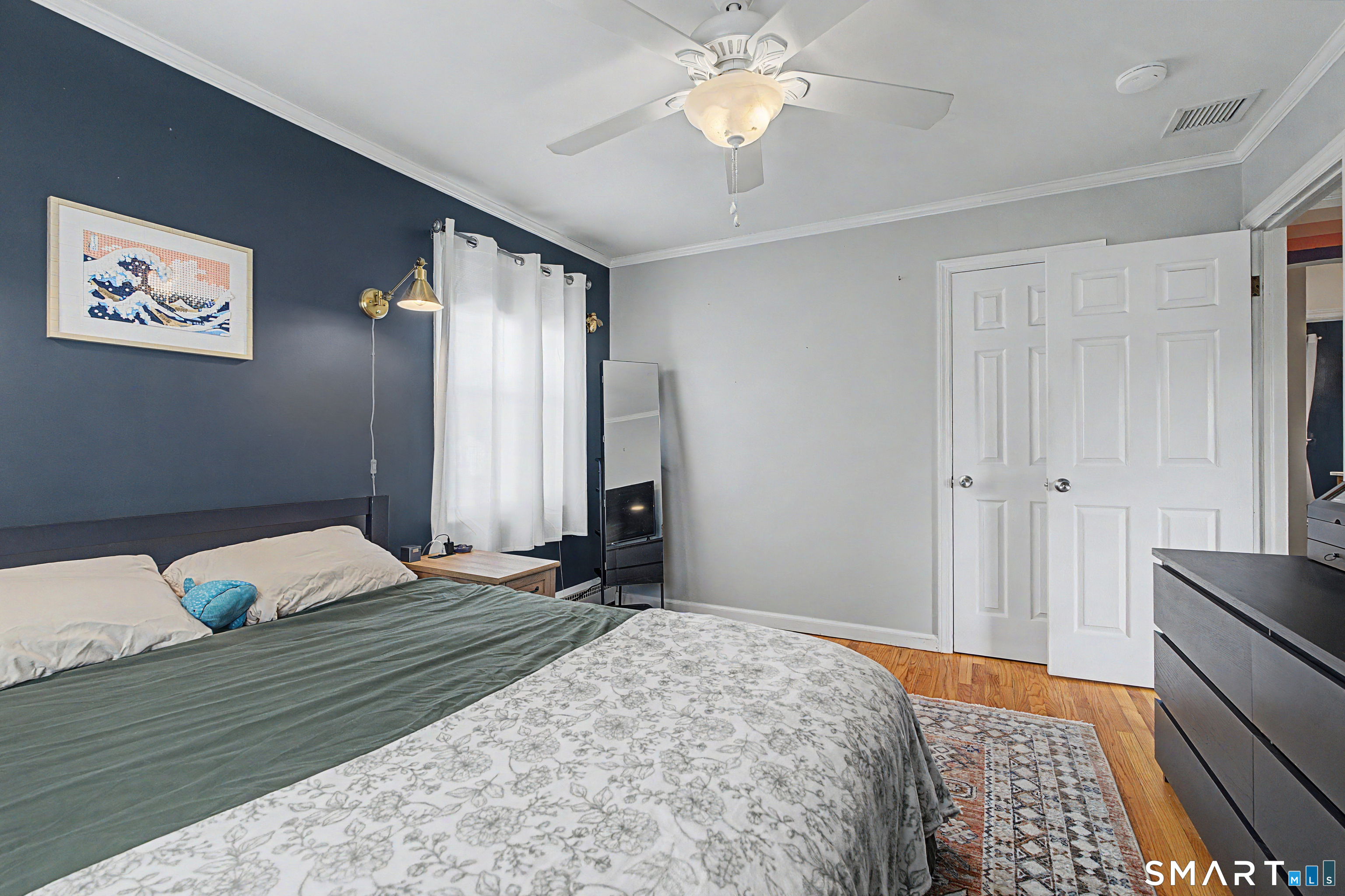 65 Jones Hill Road West Haven, CT 06516 - Photo 21 of 40 a bedroom with a bed and a chandelier