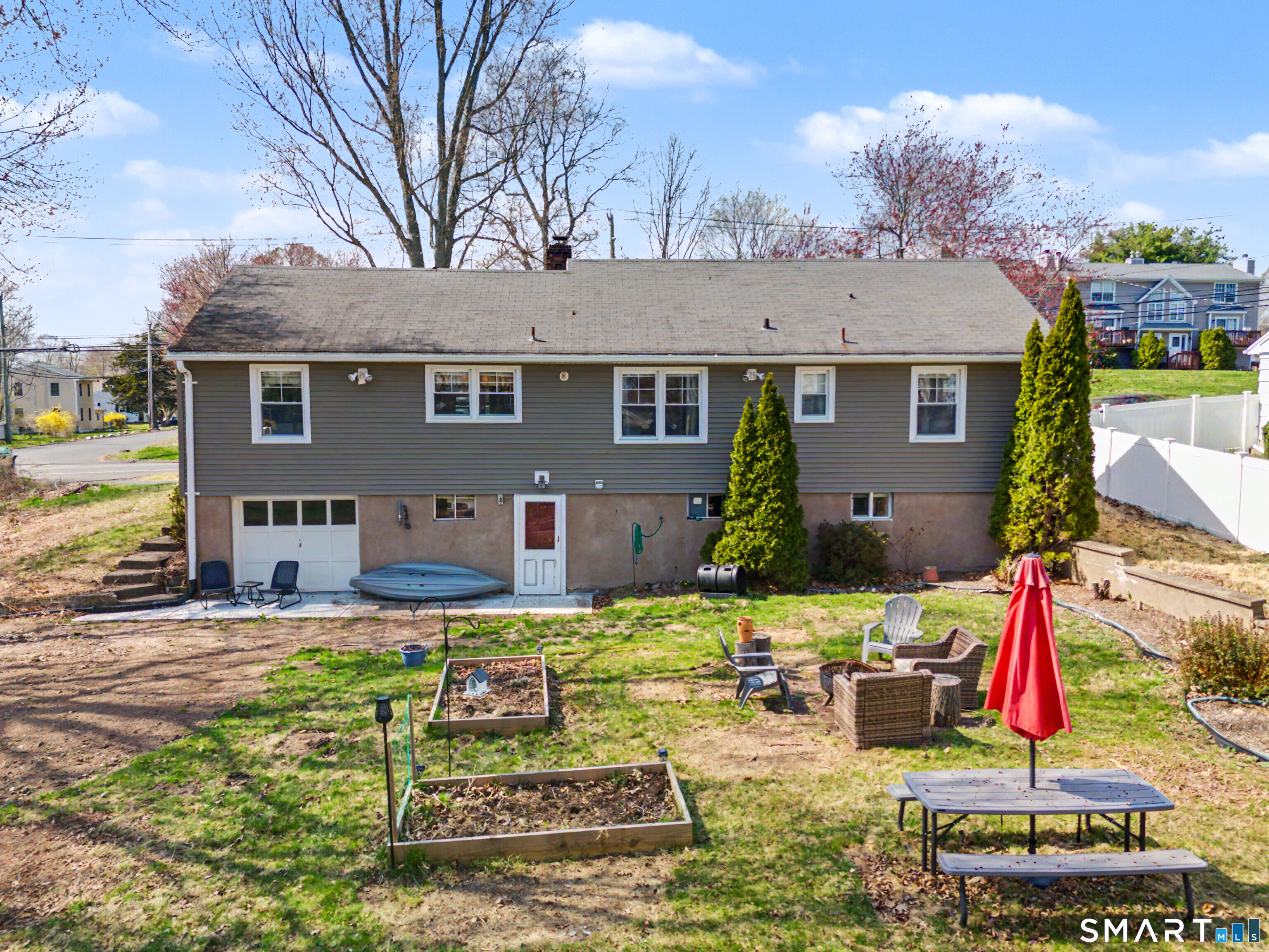 65 Jones Hill Road West Haven, CT 06516 - Photo 31 of 40 a view of a house with backyard sitting area and swimming pool