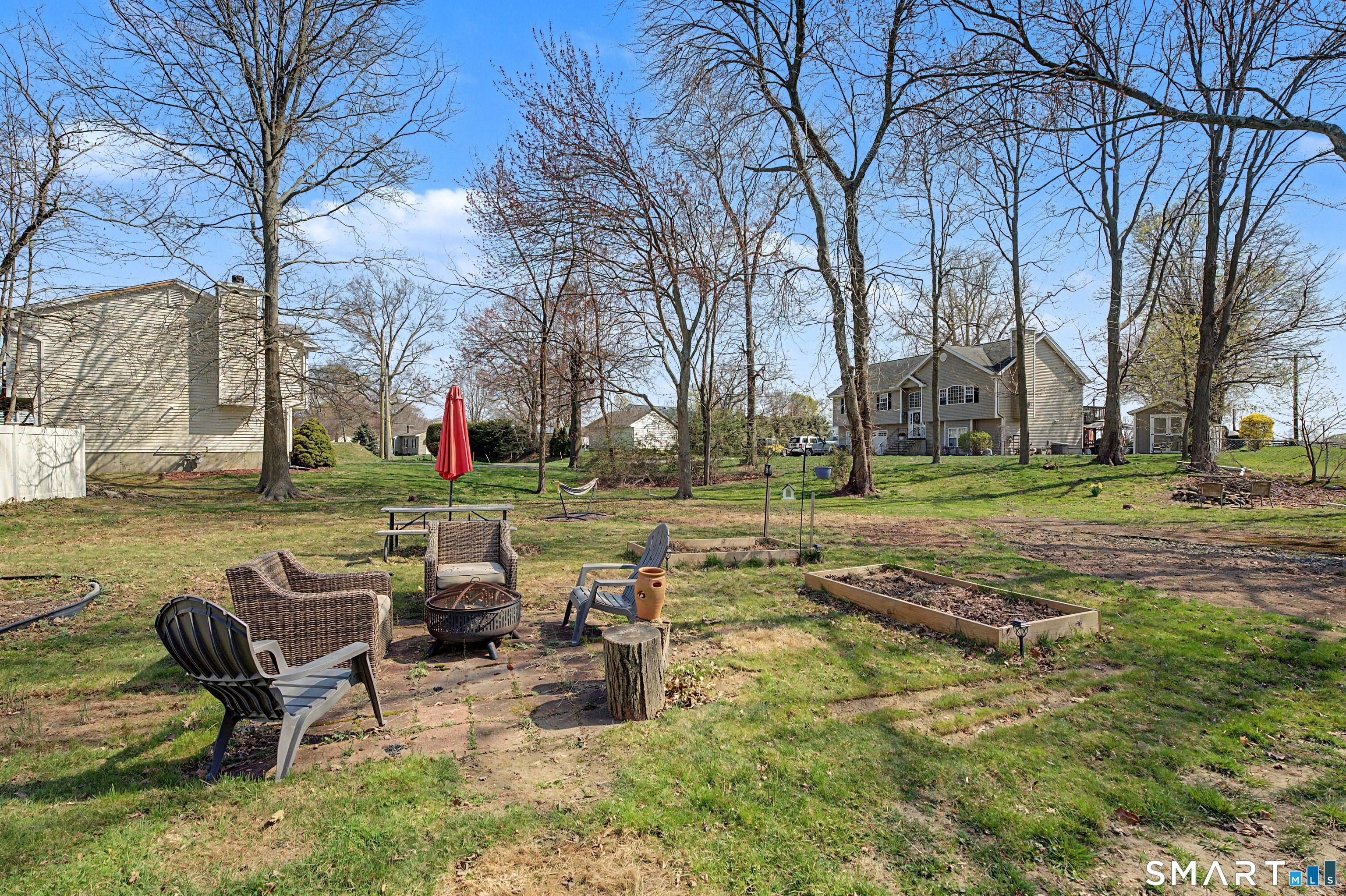 65 Jones Hill Road West Haven, CT 06516 - Photo 34 of 40 a view of a lake with lawn chairs and a fire pit