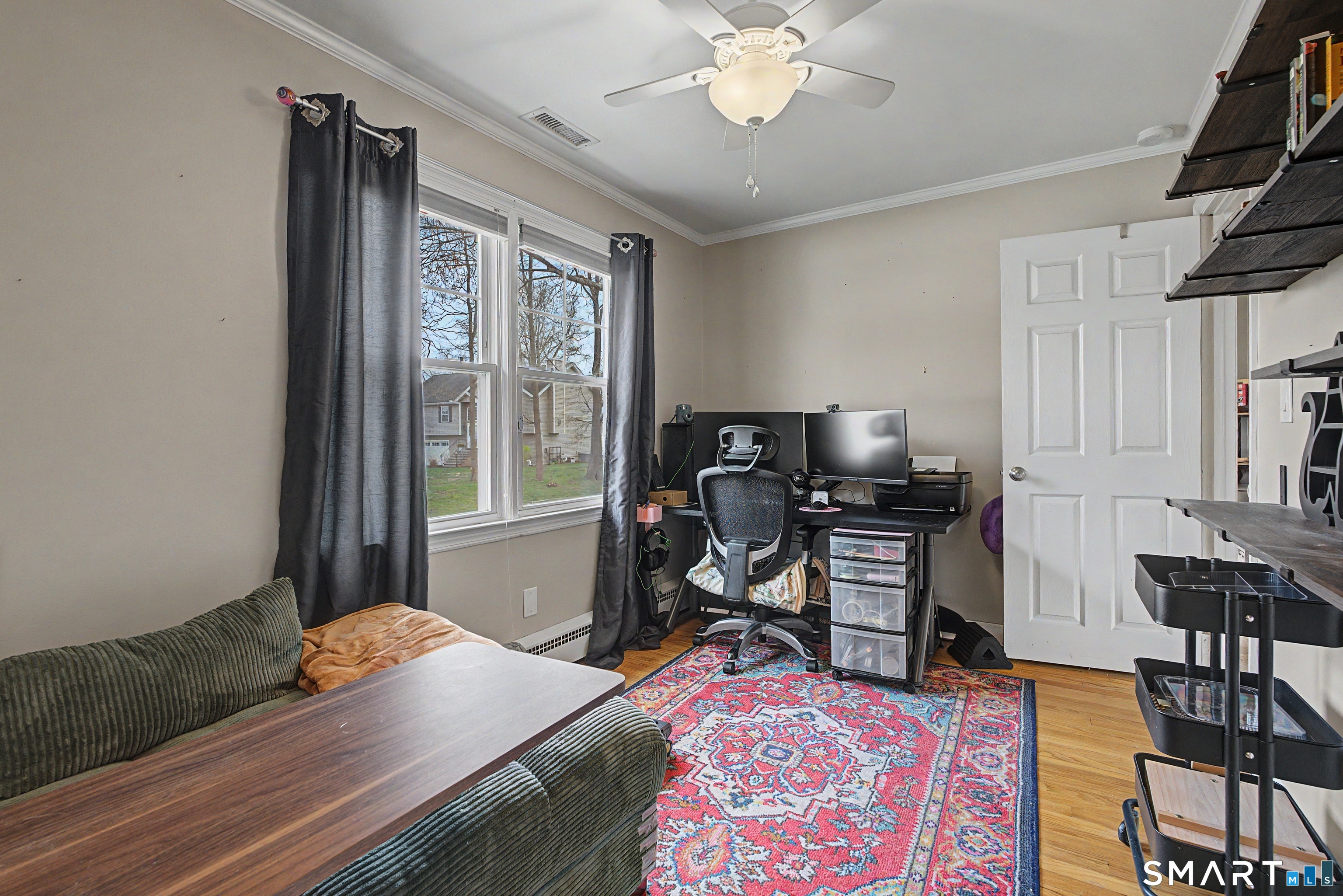 65 Jones Hill Road West Haven, CT 06516 - Photo 9 of 40 a bedroom with a bed and a table in it