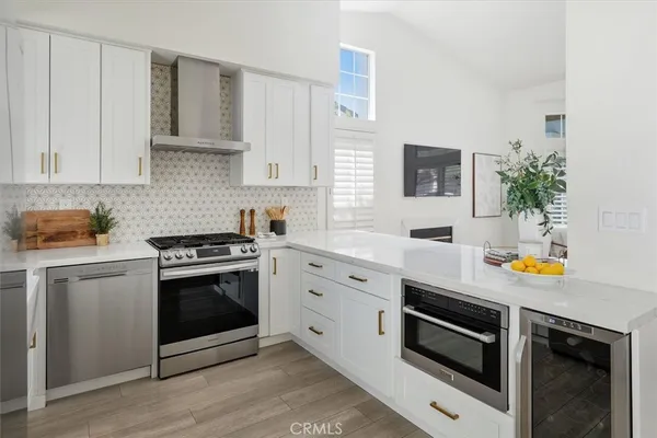 a kitchen with stainless steel appliances and white cabinets