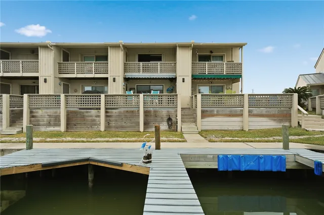 a view of a balcony with a sink and wooden floor