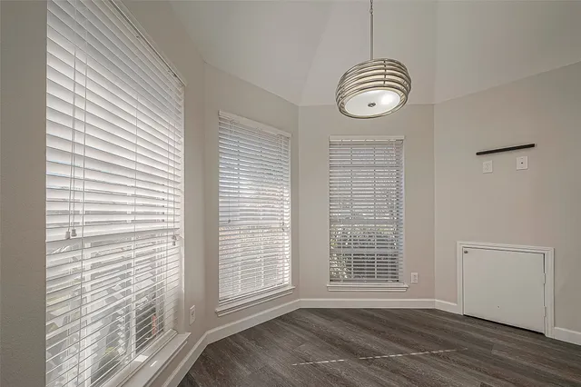a view of a livingroom with wooden floor and a window